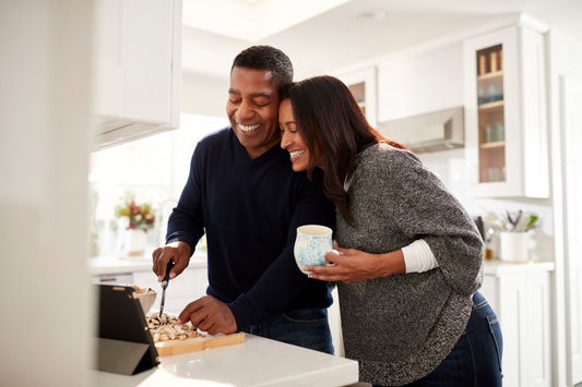 A couple cooking dinner.